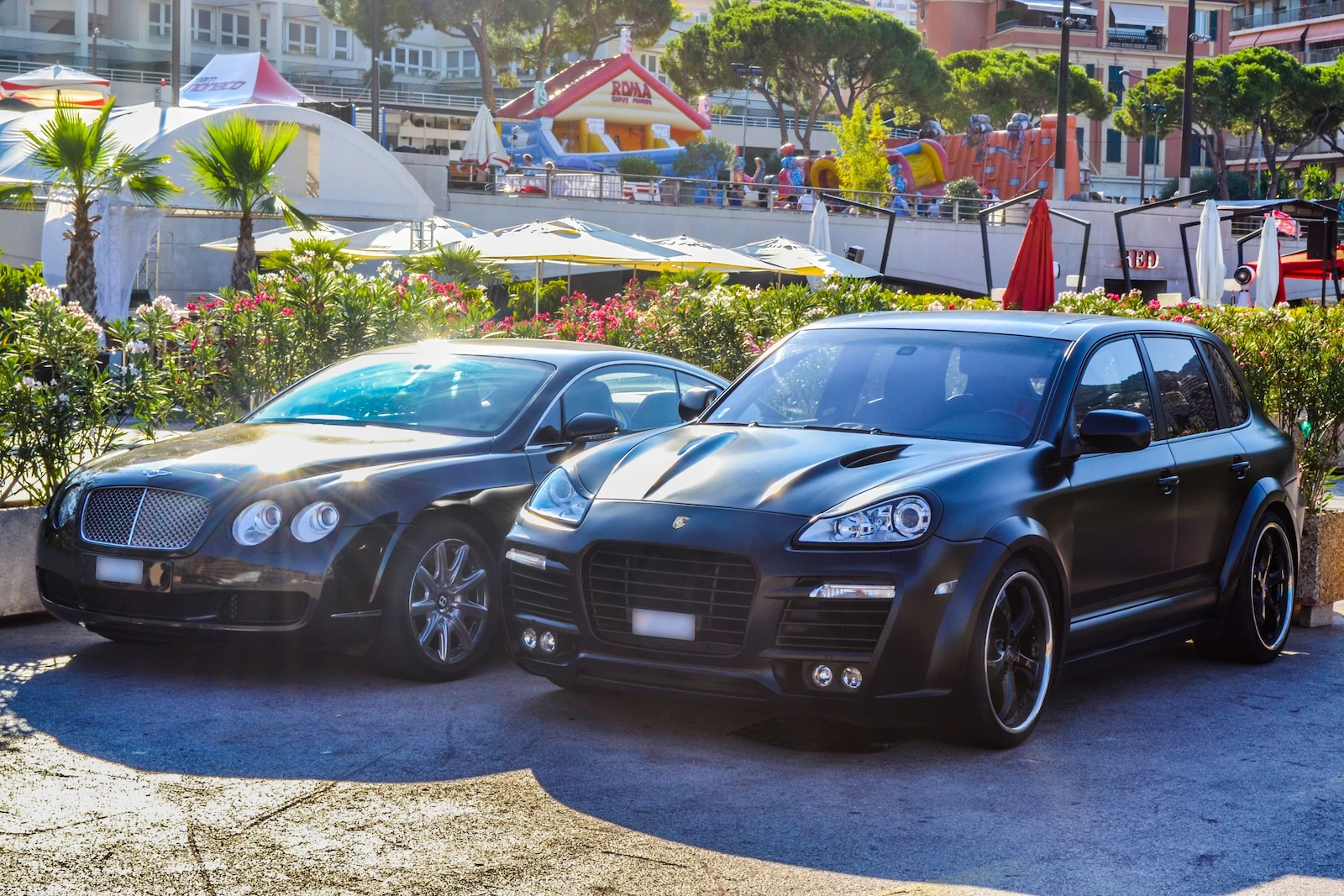 Two luxury vehicles parked side by side, representing insurance protection for high-value cars.