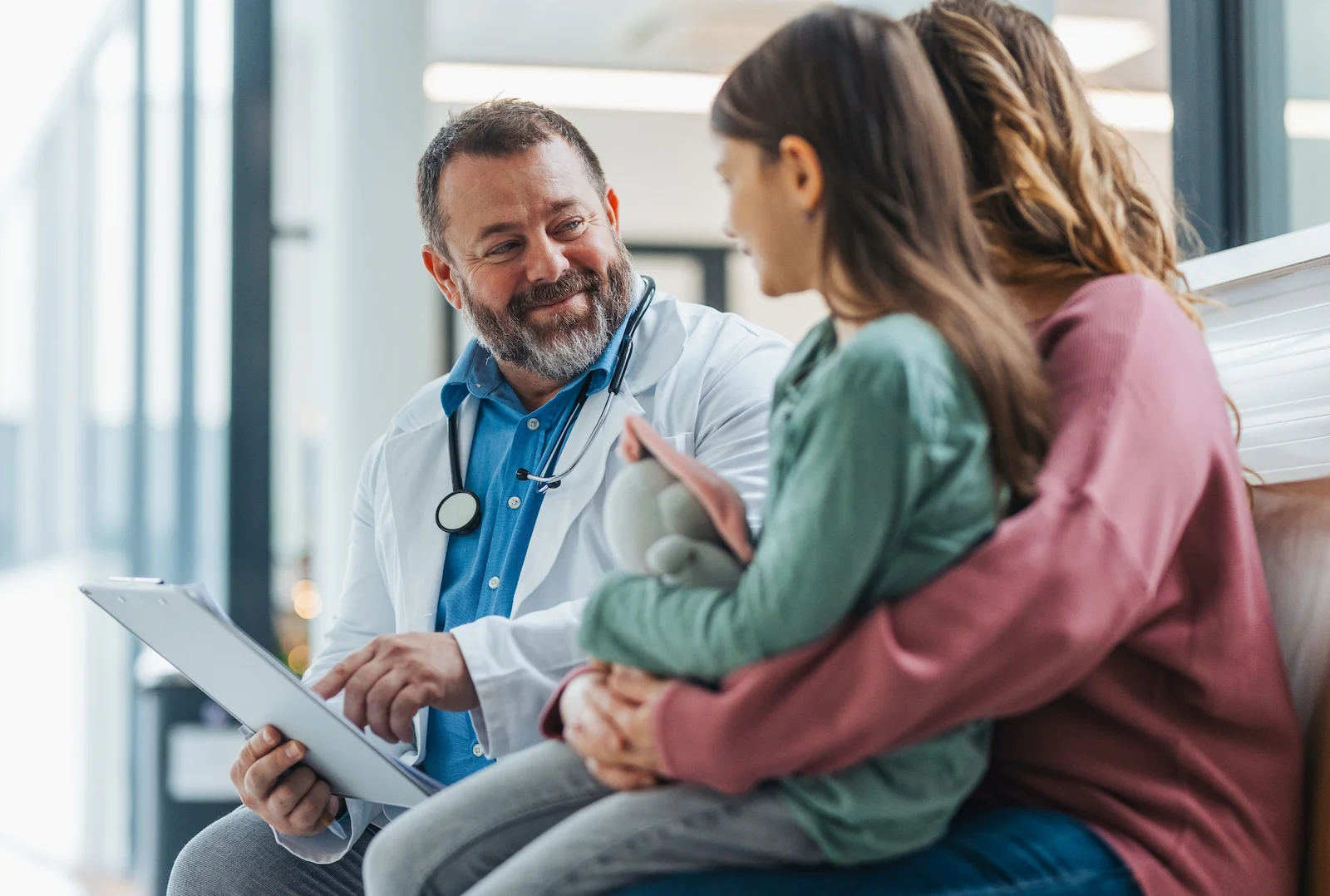 Healthcare provider consulting with a parent and child, highlighting Medical Payments and Personal Injury Protection coverage.