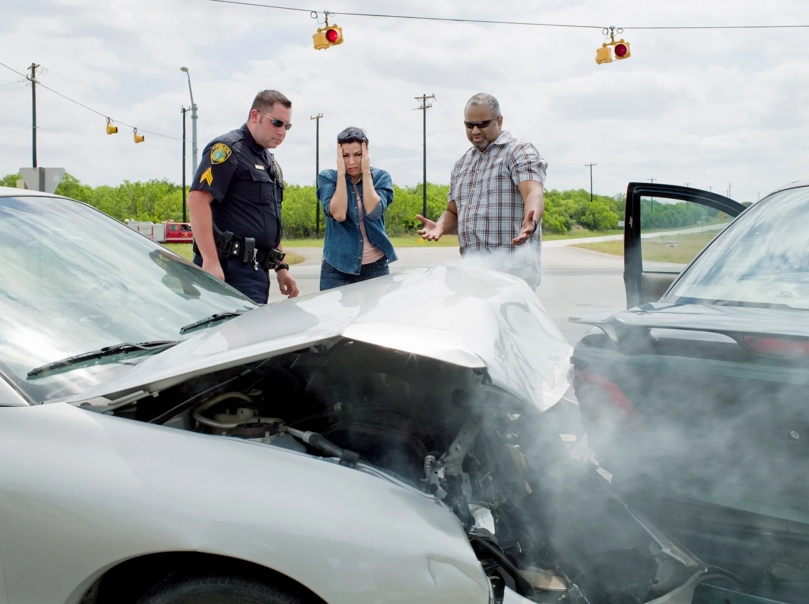 Rear-end auto accident scene with drivers and police officer, highlighting UM/UIM insurance coverage.