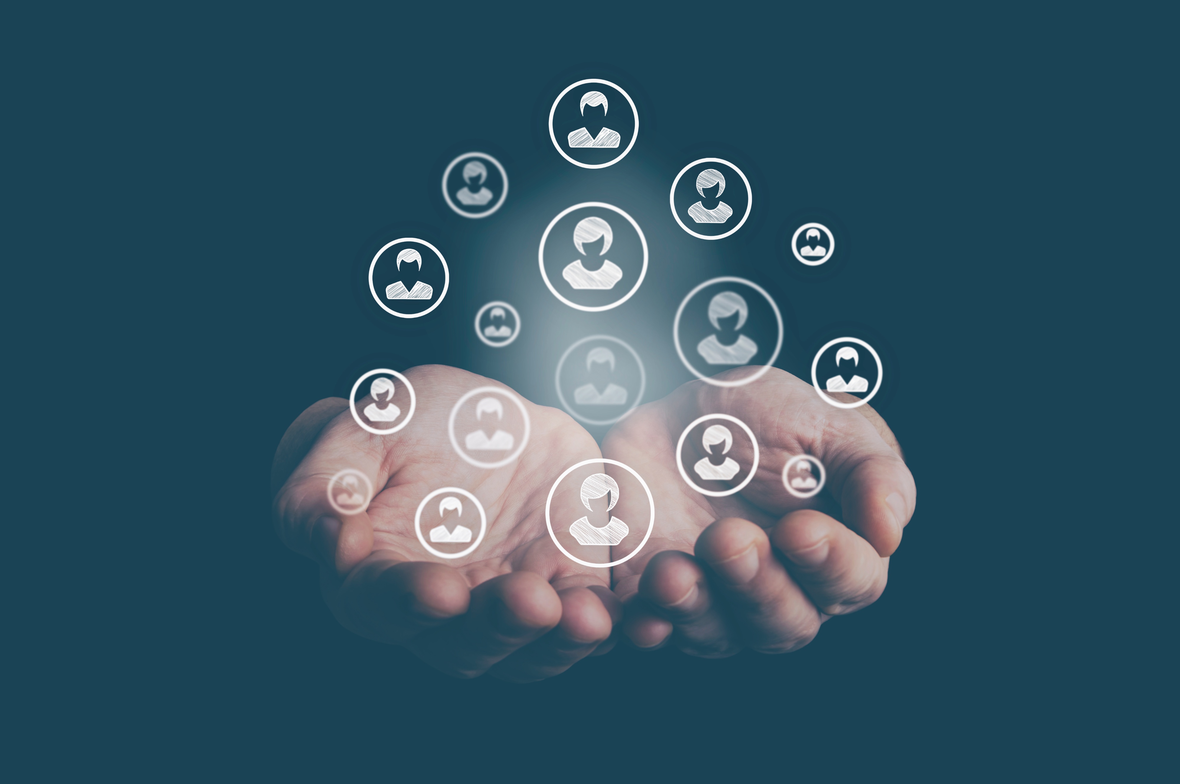 Hand holding customer profiles, representing access to trusted national and regional insurance carriers.