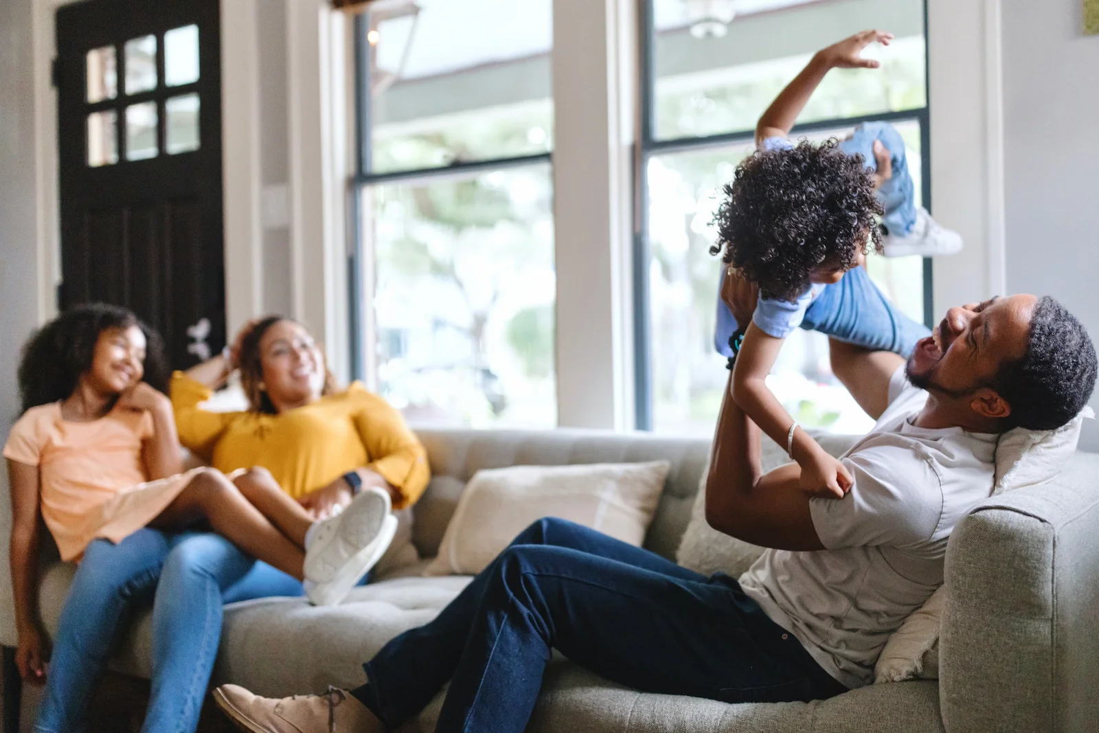 Family enjoying time together in a comfortable living room, representing homeowners insurance coverage tailored to your home and lifestyle.