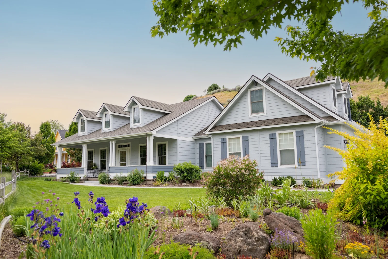 Well-maintained single-family home with landscaped yard, representing dwelling coverage under homeowners insurance protection.