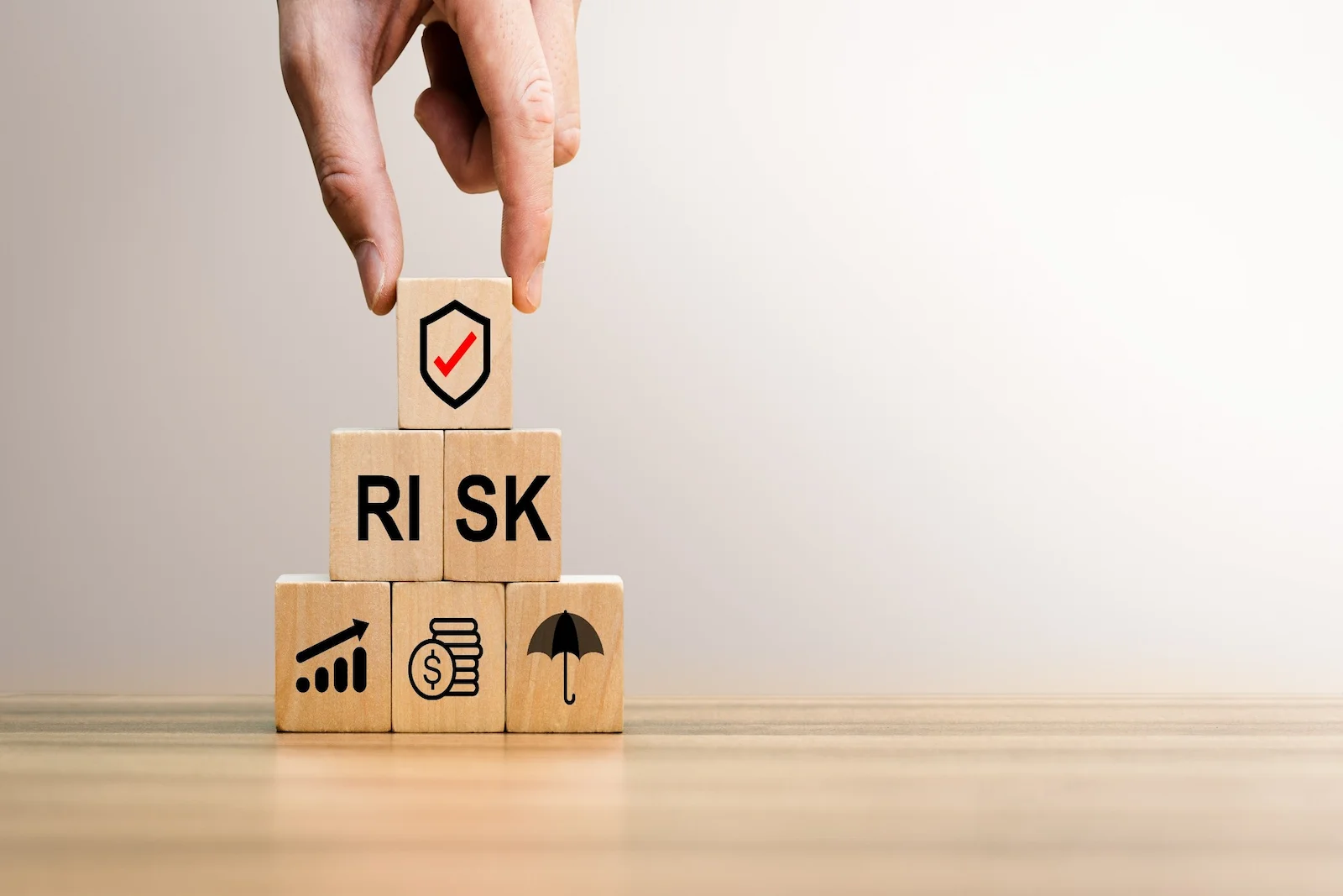 Risk protection blocks with shield symbol, representing homeowners insurance liability coverage for injuries that occur on your property.