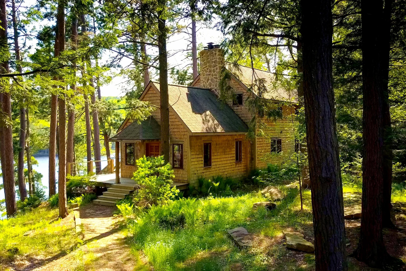 Wooded lakeside vacation home surrounded by trees, representing homeowners insurance coverage for seasonal and secondary residences.