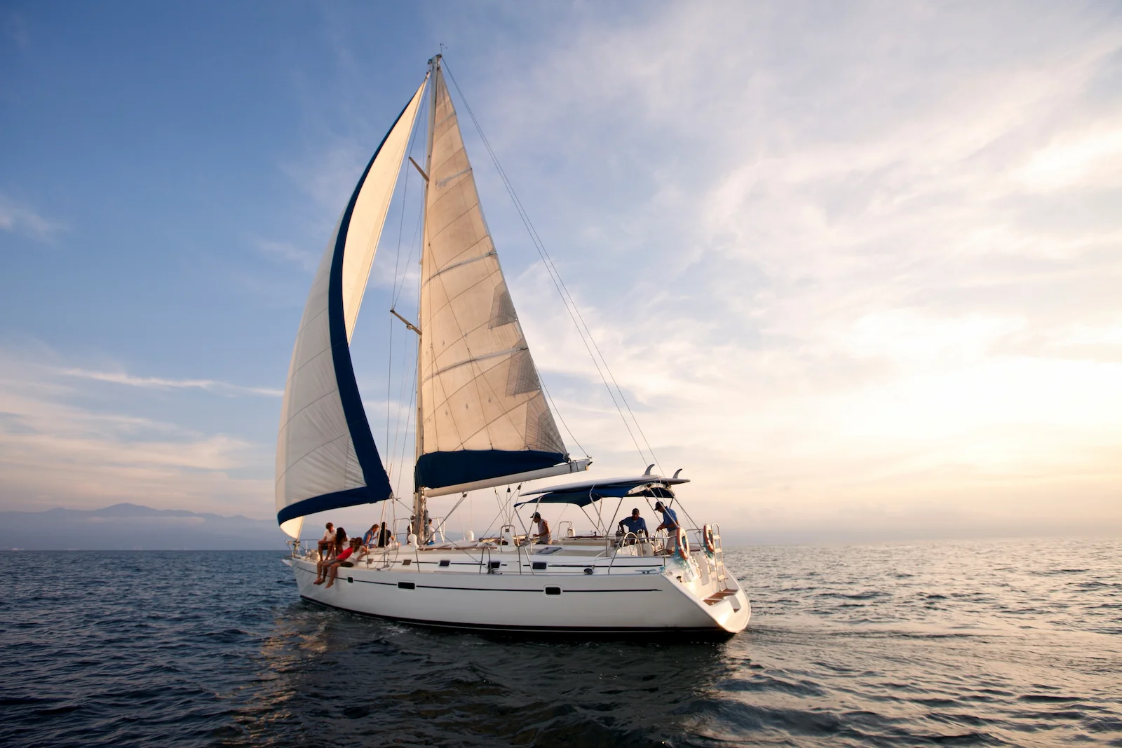 Luxury sailboat sailing across calm waters, highlighting recreational vehicle insurance protection for boats and yachts.