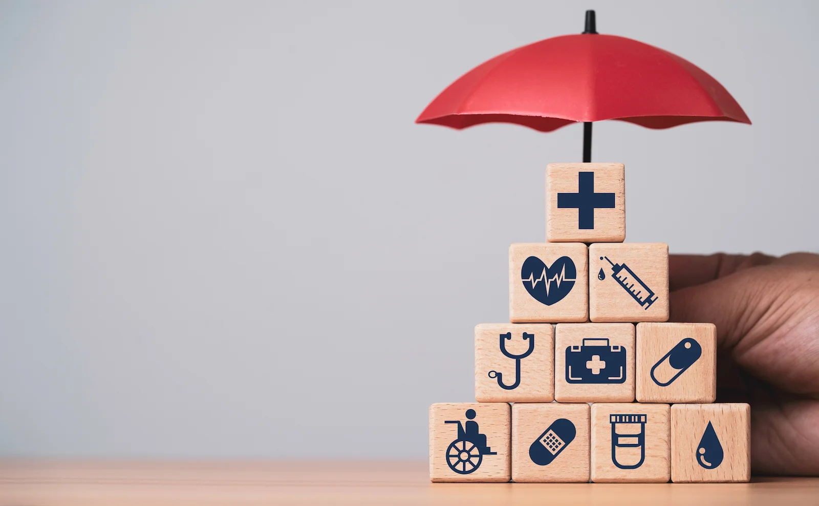 Medical care symbols protected by a red umbrella, representing bodily injury liability coverage for injury-related claims.