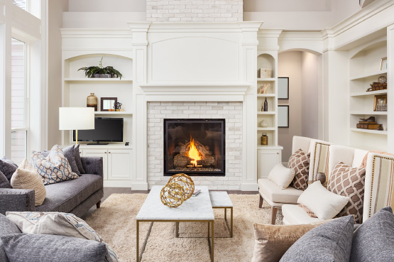 Cozy living room with sofa set and fireplace, representing comfort and protection through renters insurance coverage.