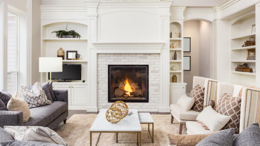 Cozy living room with sofa set and fireplace, representing comfort and protection through renters insurance coverage.